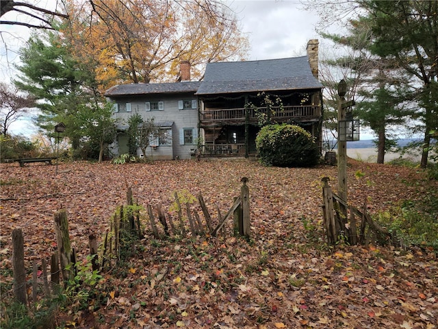 back of house with a chimney