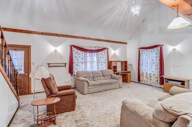 living room featuring stairs, a high ceiling, a healthy amount of sunlight, and light colored carpet