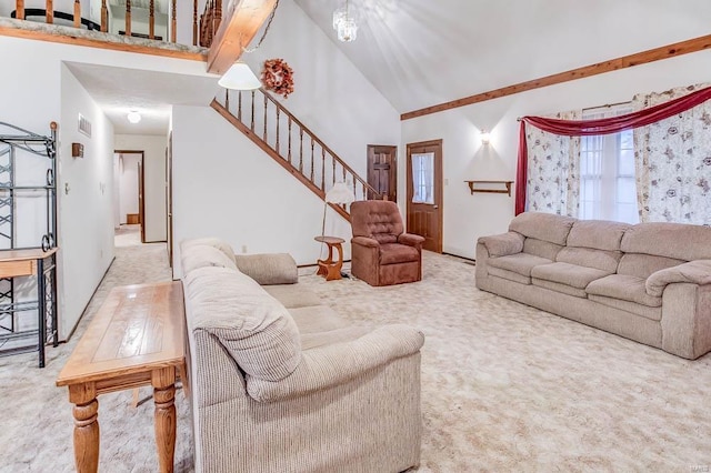 living area with stairs and high vaulted ceiling