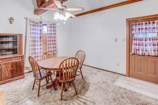 dining area featuring light carpet, a ceiling fan, and baseboards