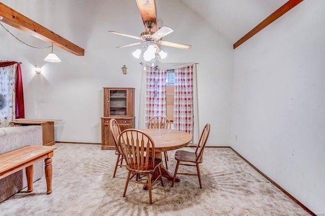 carpeted dining room featuring vaulted ceiling with beams, baseboards, and a ceiling fan