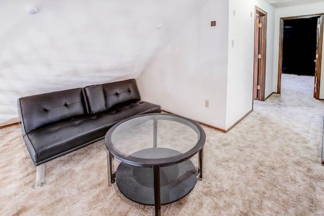 living room with baseboards and light colored carpet