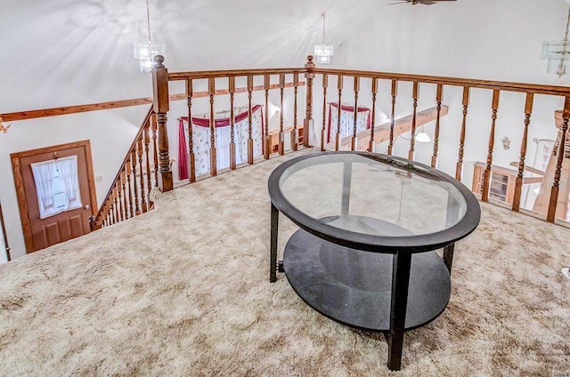 sitting room featuring carpet flooring and an upstairs landing