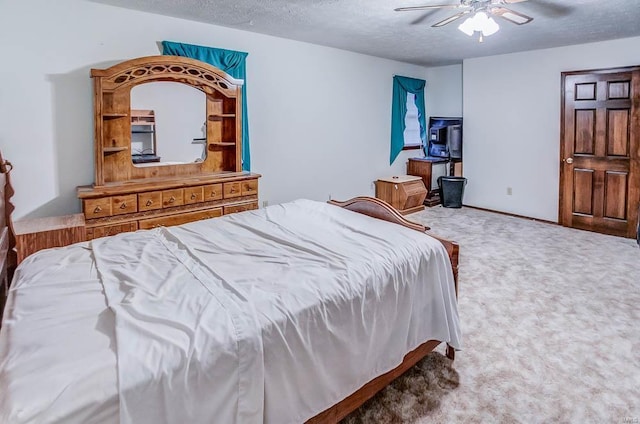 bedroom featuring carpet floors, ceiling fan, and a textured ceiling