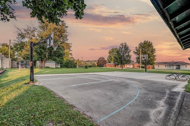 view of sport court with a yard, community basketball court, and fence