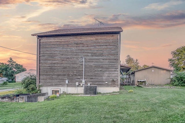 view of side of property featuring a yard and central AC unit