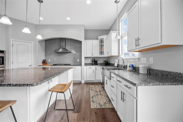 kitchen with backsplash, glass insert cabinets, appliances with stainless steel finishes, dark wood-style floors, and white cabinets