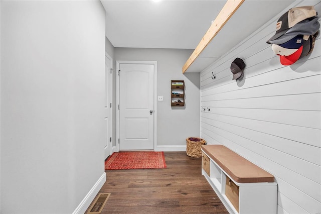 mudroom with visible vents, baseboards, and dark wood finished floors