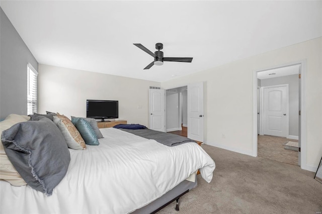 carpeted bedroom featuring a ceiling fan and baseboards