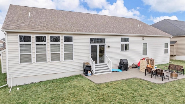 back of house featuring a patio, a lawn, and roof with shingles