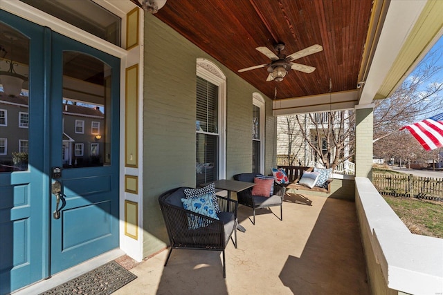 view of patio / terrace featuring a ceiling fan, fence, french doors, and covered porch