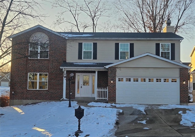 traditional home with a garage, a chimney, and brick siding