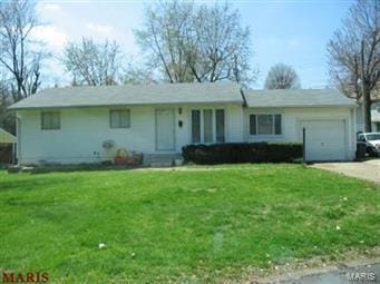 single story home with a garage, a front yard, and driveway