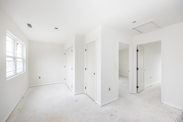 empty room featuring attic access