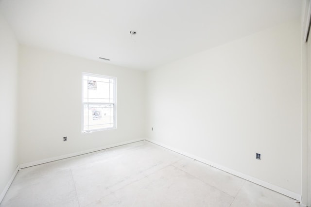 unfurnished room featuring visible vents and baseboards