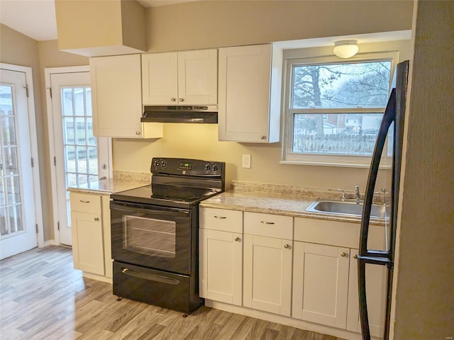 kitchen featuring light countertops, light wood-style floors, white cabinetry, black range with electric cooktop, and under cabinet range hood