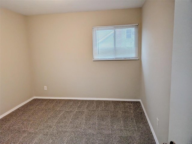 empty room with baseboards and carpet flooring