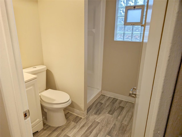 full bathroom featuring baseboards, vanity, toilet, and wood finished floors