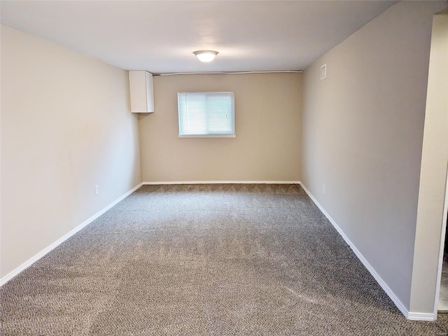 carpeted spare room with baseboards