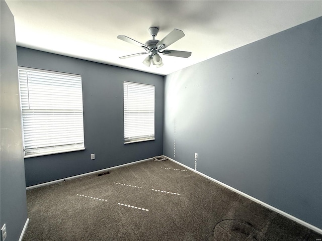 unfurnished room with a ceiling fan, baseboards, visible vents, and carpet flooring