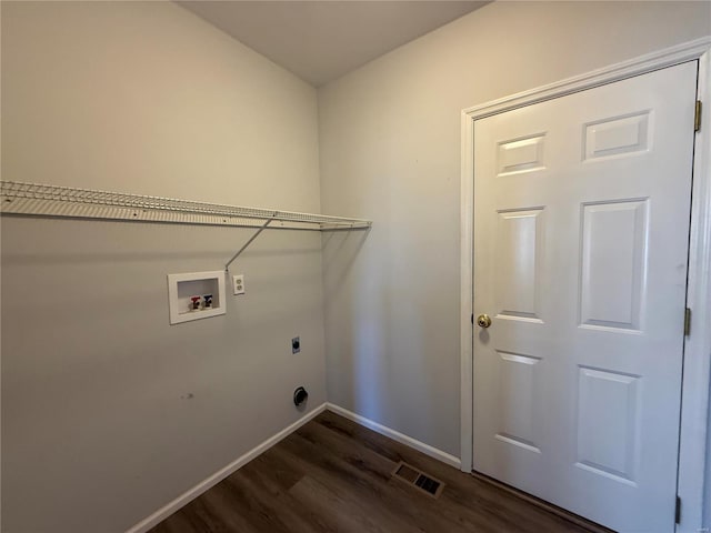 washroom with washer hookup, dark wood finished floors, electric dryer hookup, laundry area, and baseboards