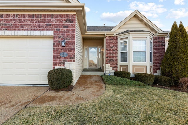 doorway to property featuring a garage and brick siding