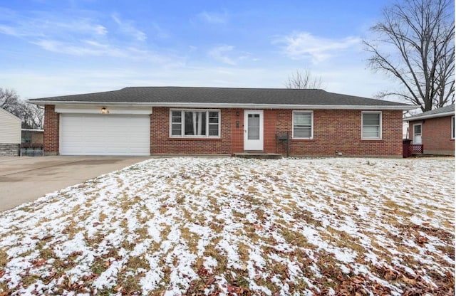 ranch-style house with brick siding, an attached garage, driveway, and roof with shingles