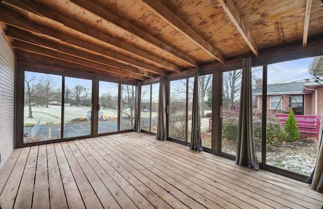 unfurnished sunroom featuring beamed ceiling and wood ceiling