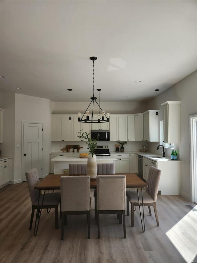 dining area featuring light wood-style flooring and baseboards