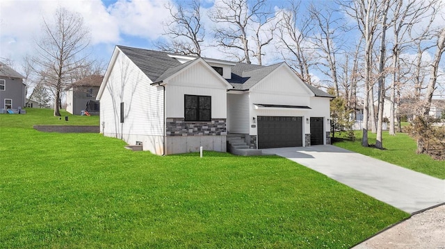 modern farmhouse featuring driveway, a front lawn, stone siding, board and batten siding, and an attached garage