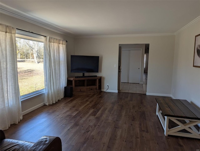 unfurnished living room with ornamental molding, dark wood-style flooring, and baseboards