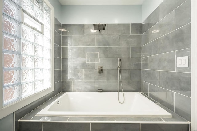 full bathroom with tiled bath, a healthy amount of sunlight, and tiled shower