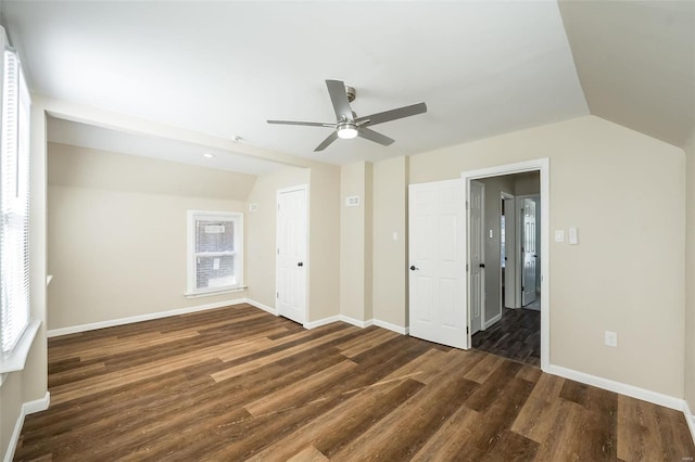 unfurnished bedroom with lofted ceiling, ceiling fan, baseboards, and wood finished floors