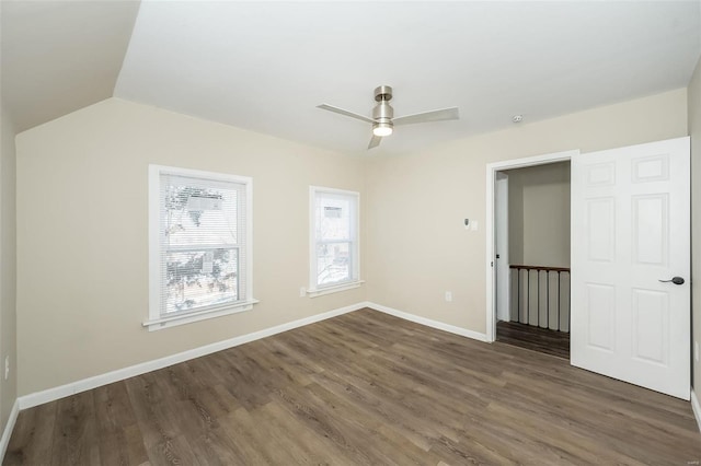 unfurnished bedroom featuring vaulted ceiling, ceiling fan, baseboards, and wood finished floors