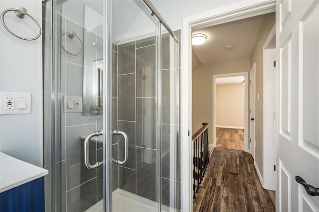 bathroom featuring a shower stall and wood finished floors