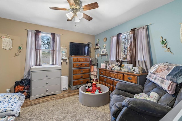 living area featuring ceiling fan and wood finished floors