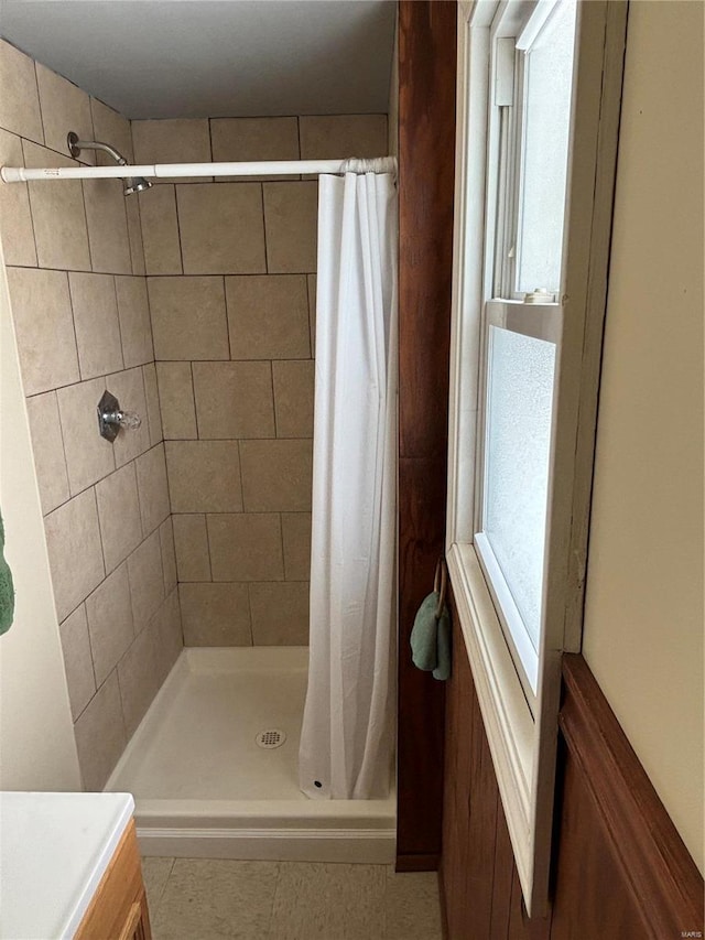 bathroom with a shower stall, vanity, and tile patterned floors