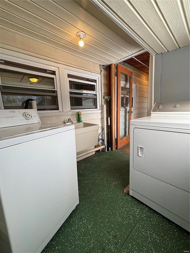 washroom featuring laundry area, a sink, and washer and dryer