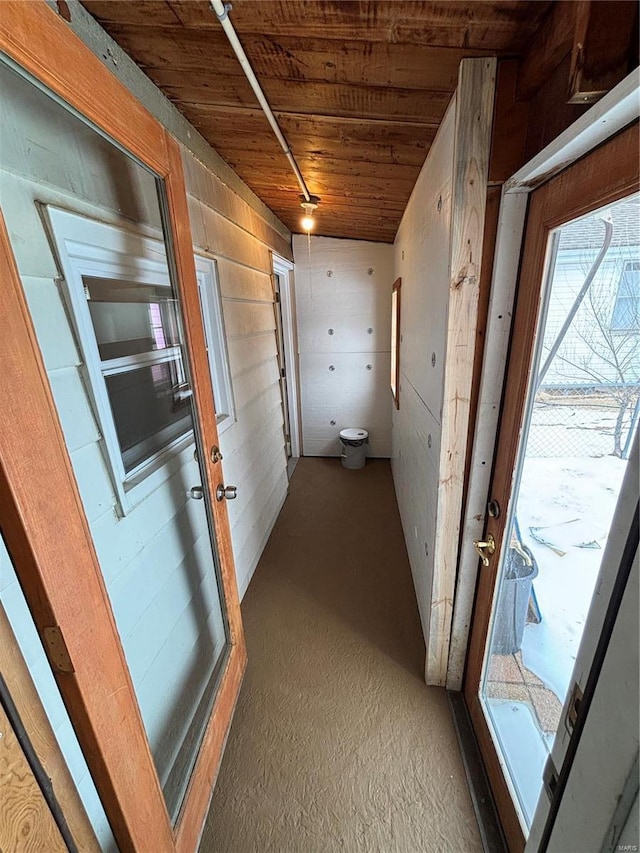 corridor with wooden ceiling and wood walls