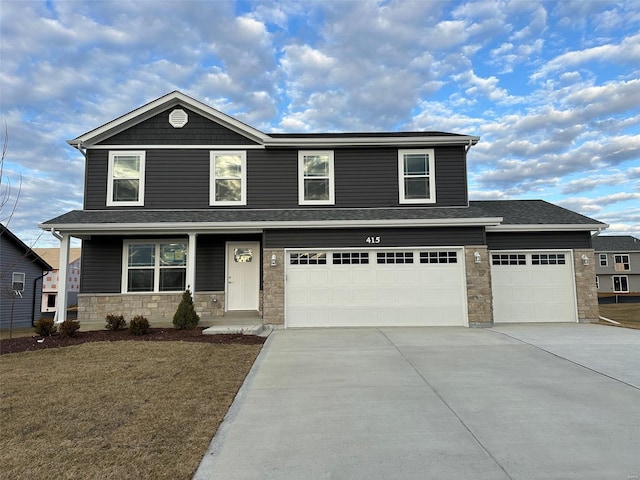 view of front facade with concrete driveway, stone siding, roof with shingles, a front lawn, and a porch