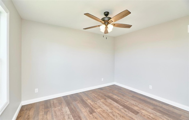 spare room featuring ceiling fan, wood finished floors, and baseboards