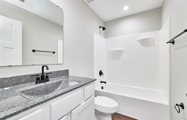 full bath with visible vents, vanity, toilet, and shower / bathtub combination