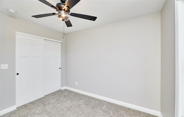 unfurnished bedroom with ceiling fan, baseboards, a closet, and light colored carpet