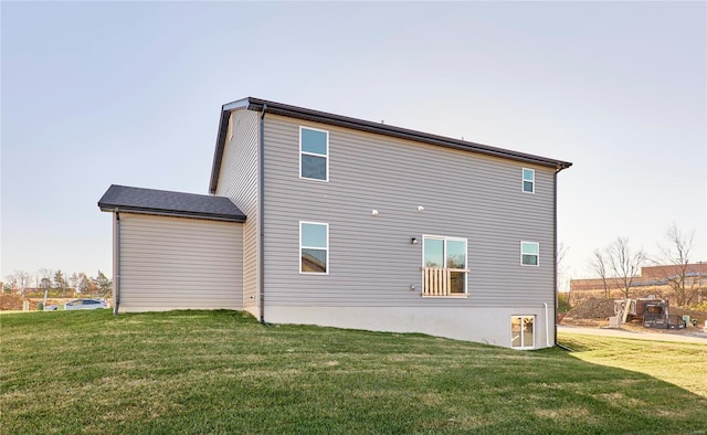 rear view of property with a lawn