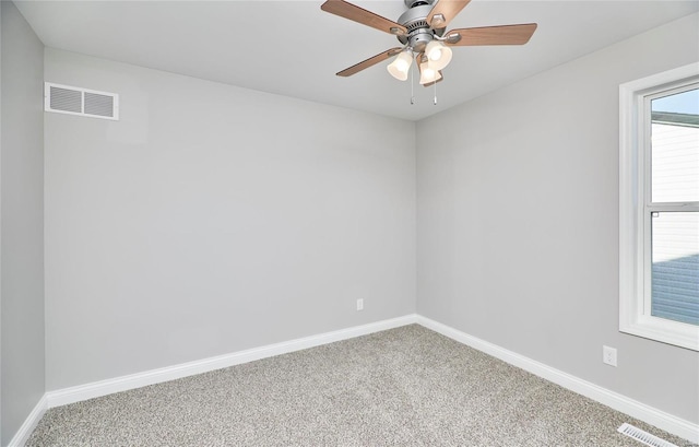 unfurnished room with carpet floors, visible vents, and baseboards