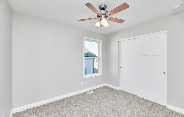 unfurnished bedroom with visible vents, baseboards, ceiling fan, carpet floors, and a closet