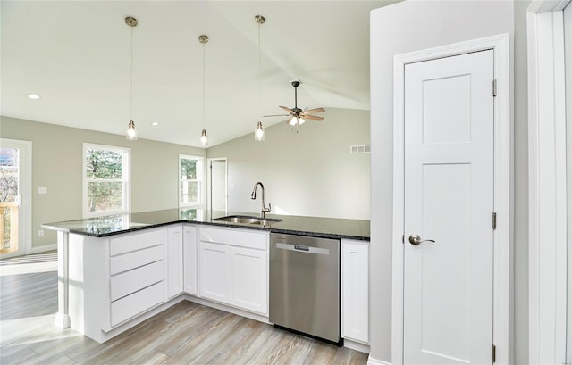 kitchen with white cabinetry, a sink, decorative light fixtures, and stainless steel dishwasher