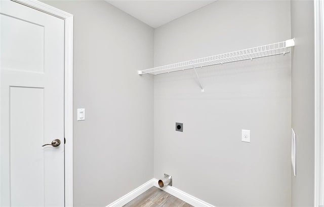 laundry room with laundry area, wood finished floors, electric dryer hookup, and baseboards