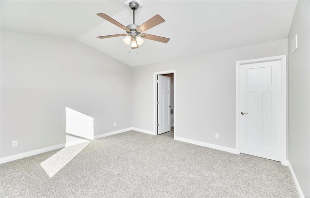 unfurnished room featuring vaulted ceiling, light carpet, a ceiling fan, and baseboards