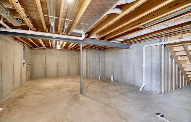 unfinished basement featuring electric panel